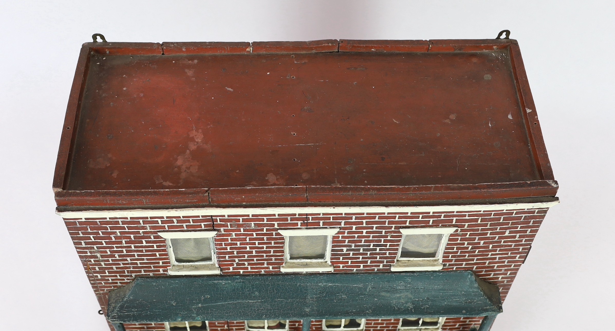 A Victorian furnished dolls’ house, circa 1890, 77cm high.